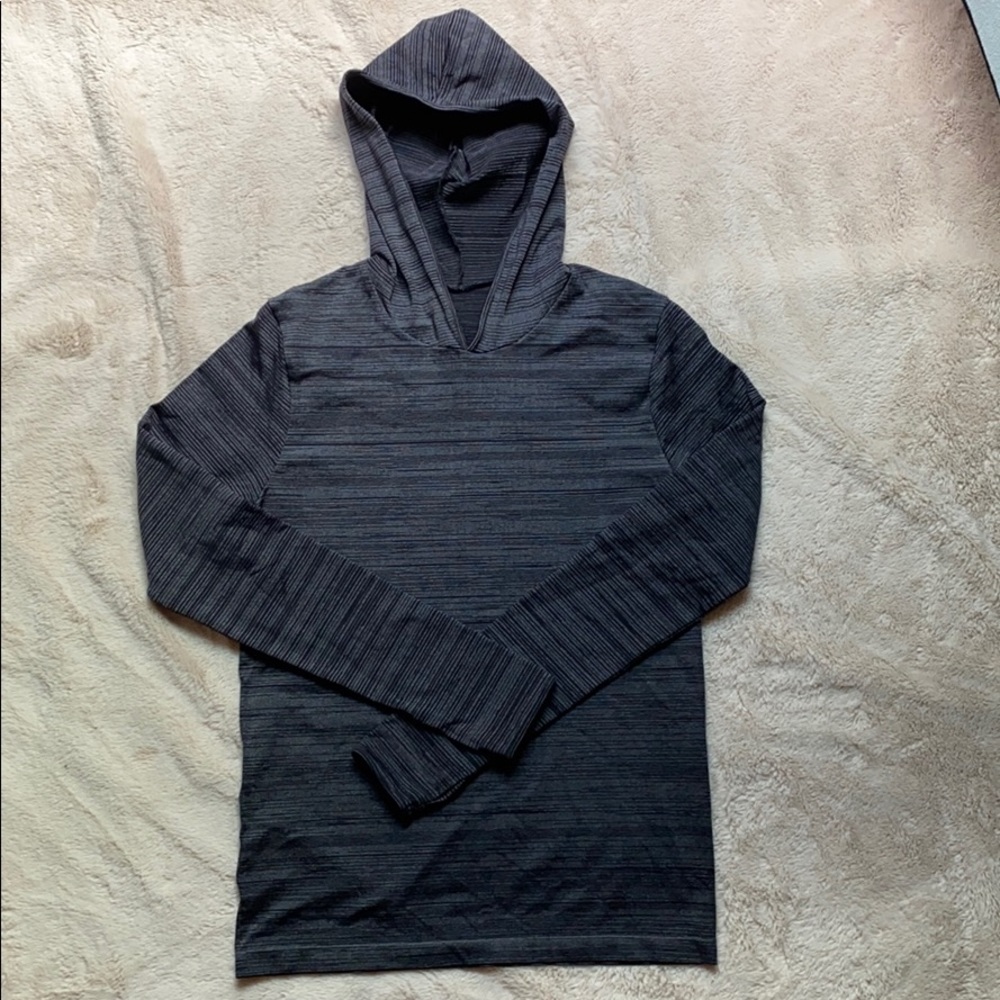 Stripped hooded pullover with thumb holes.